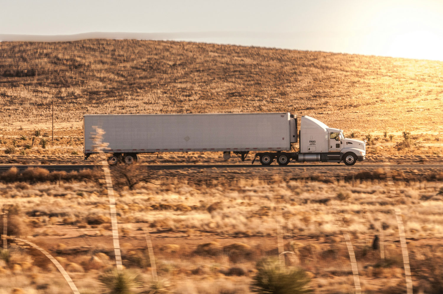 A truck crossing a desert highway